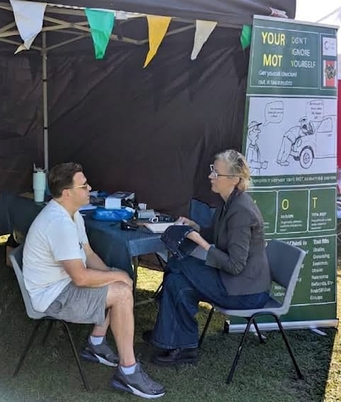 A Your MOT wellbeing check taking place at a Lemon + Aid event stall